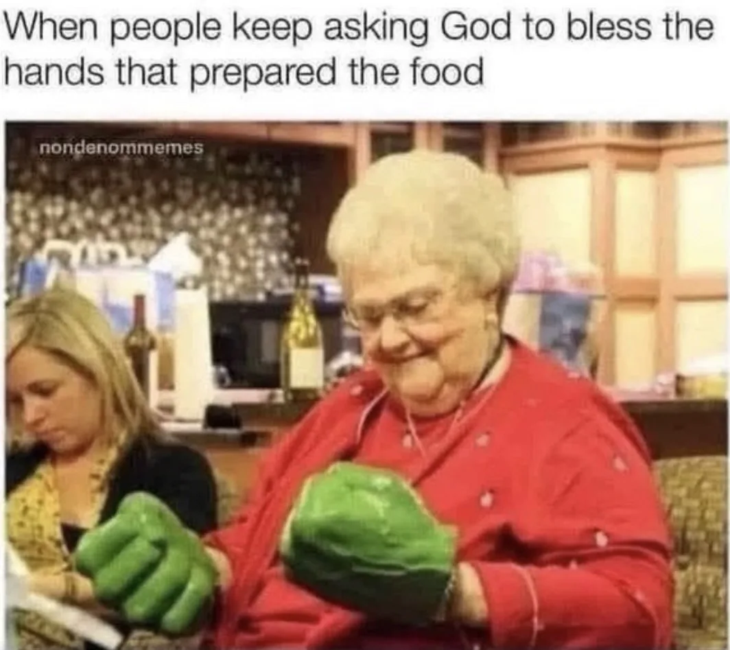 Meme captioned “When people keep asking God to bless the hands that prepared the food,” over a photo of a grandmother in a red sweater wearing giant green Hulk fists in a kitchen.