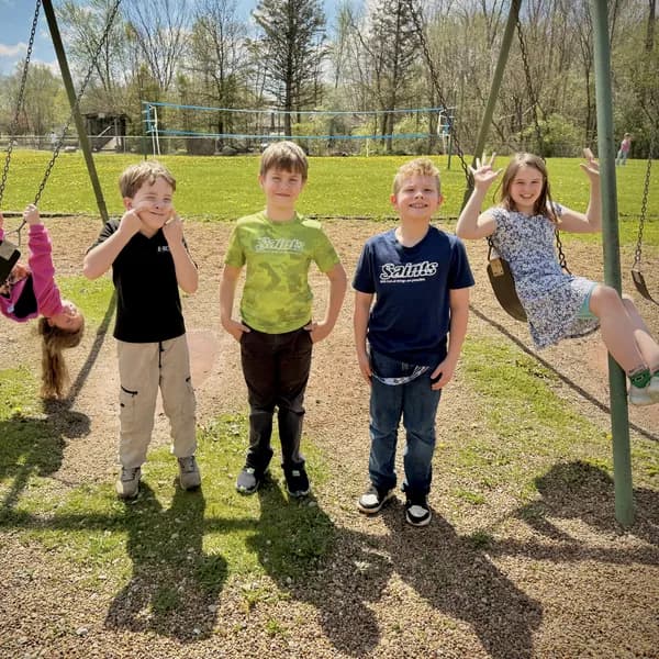 Children on the swing set at recess