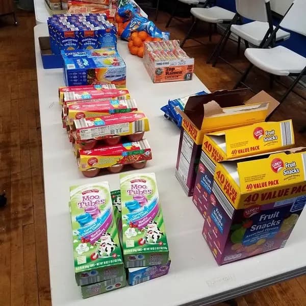 Boxes of donated snacks on a folding table